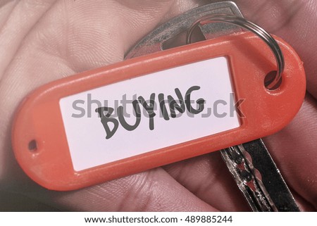 BUYING word written on key chain
