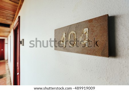 Plate with number 404 in abandoned building on the old wall