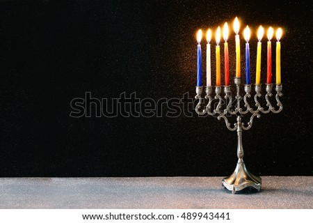 Image of jewish holiday Hanukkah background with menorah (traditional candelabra) and burning candles
