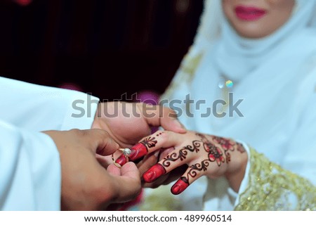 Groom put a ring on bride finger - Malay wedding