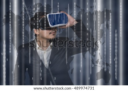 Asian Man wearing virtual reality Looking the digital numeric display of security or hacker on dark blue and world map  background, VR technology concept