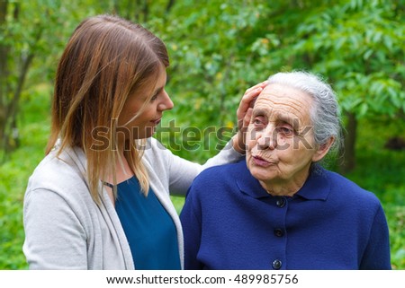 Picture of an old lady taking a walk with her granddaughter