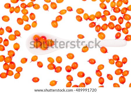 A bunch of juicy fresh fragrant sea buckthorn with white ceramic spoon on white background isolated. Royalty-Free Stock Photo #489991720