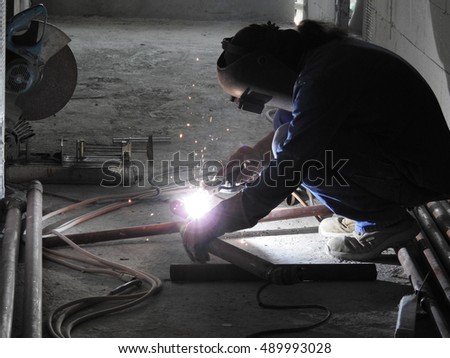 Labor welder worker in building construction site