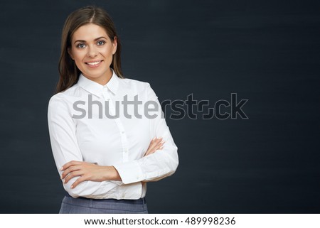Smiling business woman with crossed arms. Studio portrait on black. Isolated.