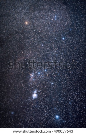 Universe space image: real photo of starry dark night sky with the winter Orion constellation. The shot was done with total exposure time 54 minutes. Several nebulae are clearly visible. 