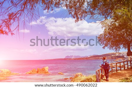 woman tourist walking on the waterfront of Chania bay backround, Crete, Greece