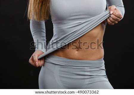 Clothing fashion sport concept. Part body picture with thermoactive underwear. Attractive fit woman promoting sporty clothes.