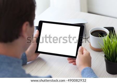 man sitting at desk in office and holding tablet computer with isolated screen