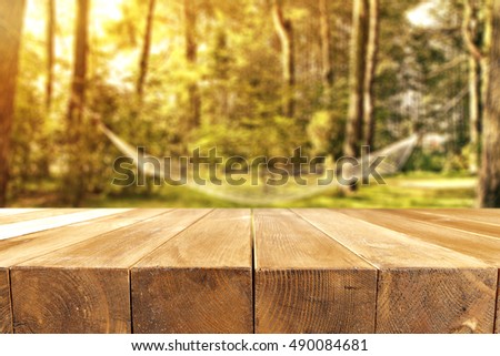 wooden big table place and autumn background of forest 