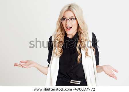 Happy and surprised young confident business lady, looking at camera, white background. Place for you text on the right