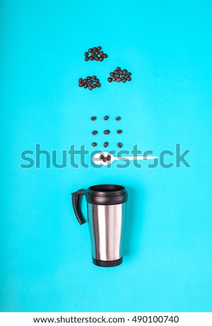 Coffee beans spilling out of a cup of coffee from the clouds on a blue background