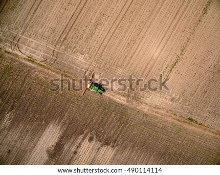 Aerial view on an agricultural crops sprayer in a field