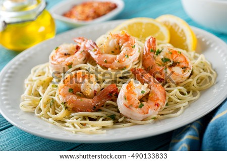 A delicious plate of shrimp scampi with spaghetti and lemon. Royalty-Free Stock Photo #490133833