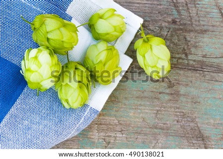 hop cones on the old wooden background, top view