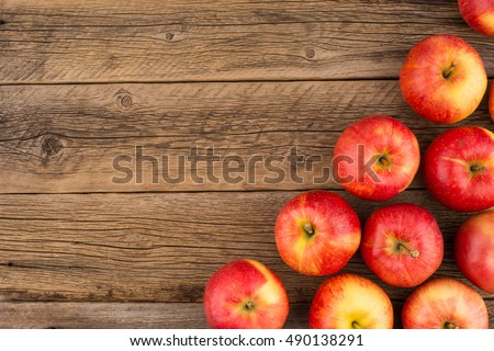 Red apples on the old wooden table. Top view.