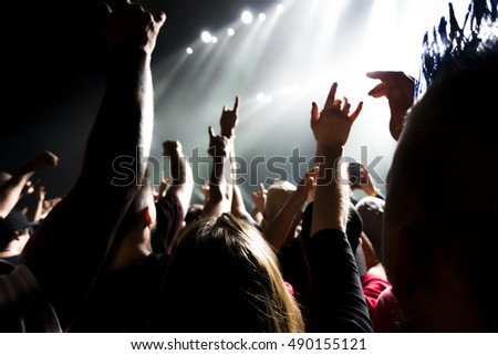 a crowd shadow of people at during a concert