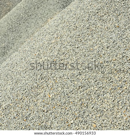 Pile of light grey gravel; Raw material for construction industry
