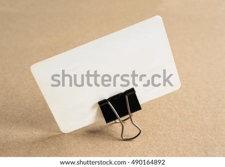 Blank business card for mockup on cardboard background.