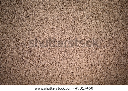 Beige dotted leather surface (vignetted)