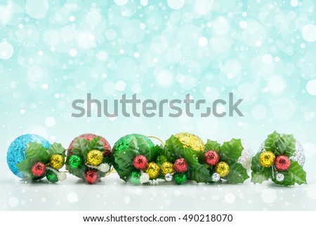 Christmas and New Year Decoration closeup, Christmas ball colorful on snow with silver abstract light over blue festive background with copy space