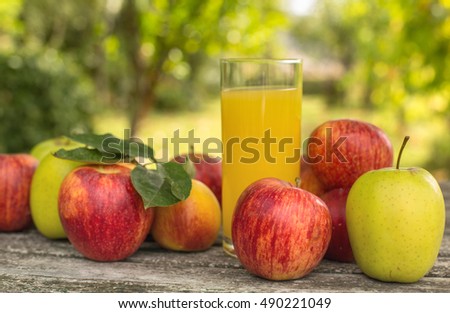 fruits and peach juice on a wooden table, outdoor