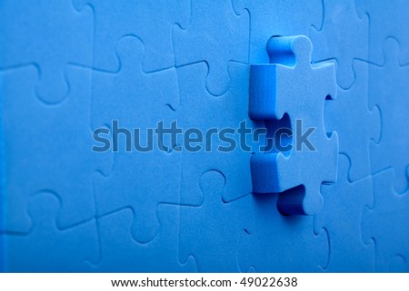 3D blue puzzle on blue background.