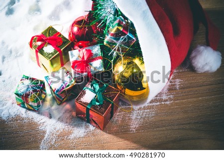 Christmas decorations backgrounds, Christmas red balls and Gift box in red santa claus hat decorations on snow