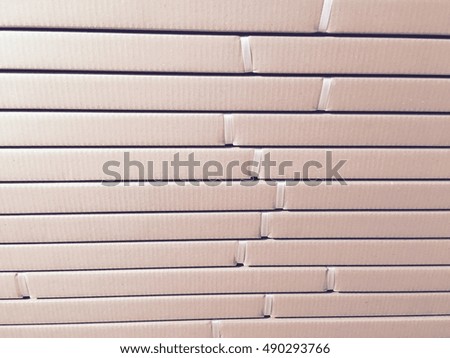 Shipment, logistics, delivery and product distribution business industrial concept: storage warehouse with row of stacked cardboard boxes with packed goods on wooden shipping pallets isolated on white