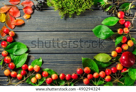 Apples, berries and leaves on wooden background. Thanksgiving,  autumn, homemade