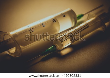 Two medical syringe close-up with a narcotic substance Royalty-Free Stock Photo #490302331
