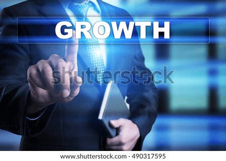 Businessman is pressing button on touch screen interface and selecting "Growth". Business concept.