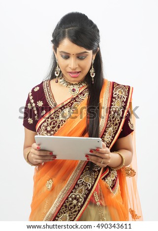 Traditional Indian woman using a tablet