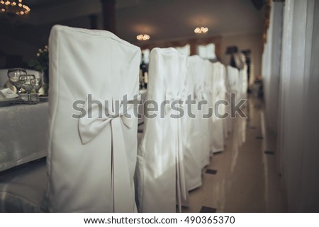 Festive wedding ceremony chair s decoration of lightweight white fabric closeup