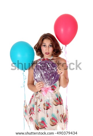 A closeup image of a gorgeous young woman with a big lollypop and
two balloons, isolated for white background.
