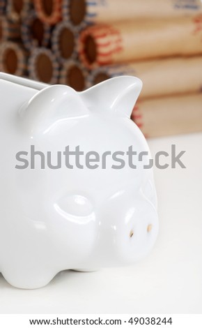 closeup piggy bank with coin rolls