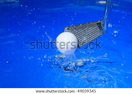 Golf club in blue water. Club with ball