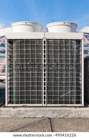 Industrial air conditioner condensers (outside unit) on the roof of a building on a hot summer day