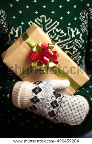 Christmas gifts. Knitted mittens. Knitted dress. Box with gifts Present