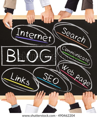 Photo of business hands holding blackboard and writing BLOG concept