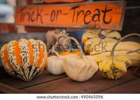 pumpkins and the "trick or treat" sign. Holiday-themed image.