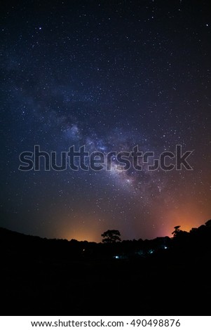Milky Way Galaxy and Silhouette of Tree with cloud.Long exposure photograph.With grain

