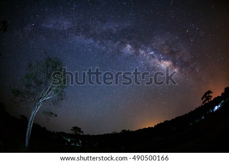 Milky Way Galaxy and Silhouette of Tree with cloud.Long exposure photograph.With grain