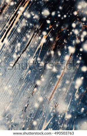 Wooden background with snowstorm. Christmas card with textured wood planks with falling snow and copy space