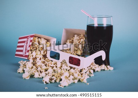 Bucket of popcorn against a blue background Vintage Retro Filter.