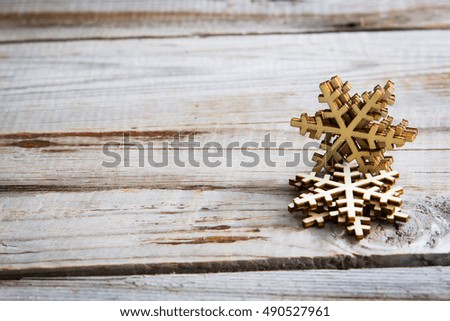 Snowflakes on wooden background. Winter holidays concept.