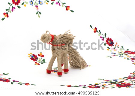 horse in tarditsionny style against the background of a color cloth