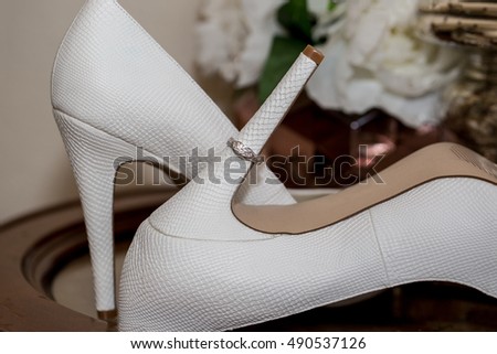 Wedding ring and white shoes. Wedding. Ring
