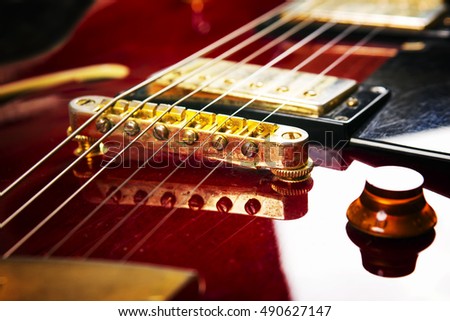 Red acoustic guitar close up in dark background