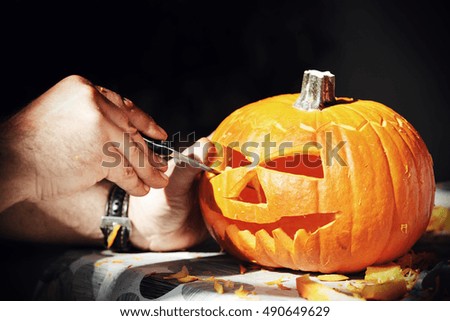 halloween pumpkin and hands with knife 
